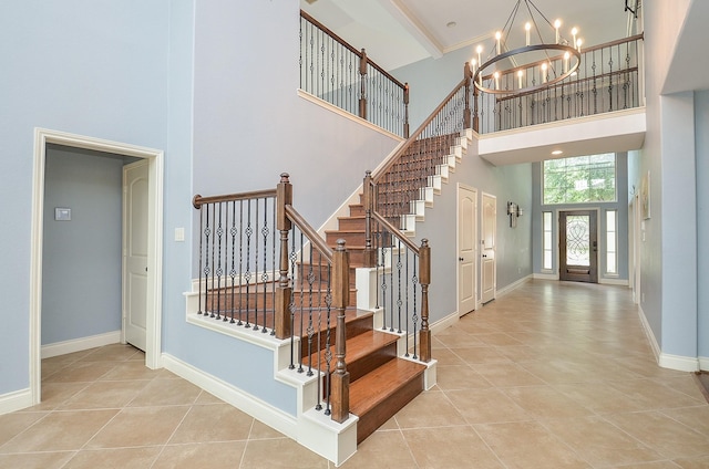 28722 Maple Red Dr, Katy, TX 77494 - stairway with a towering ceiling, a chandelier, and tile patterned flooring
