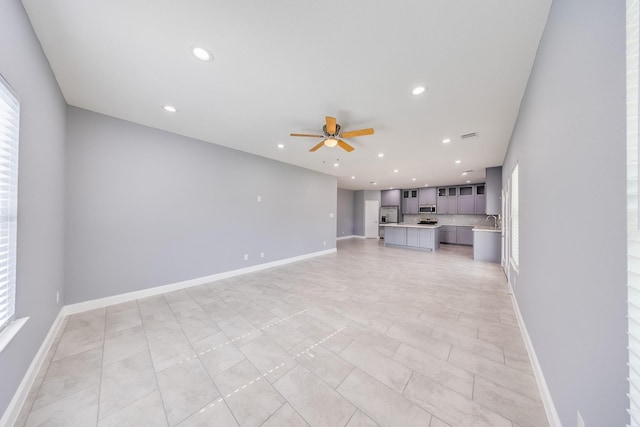 5402 Oriole St, Houston, TX 77017 - unfurnished living room with a ceiling fan, recessed lighting, and light tile patterned floors