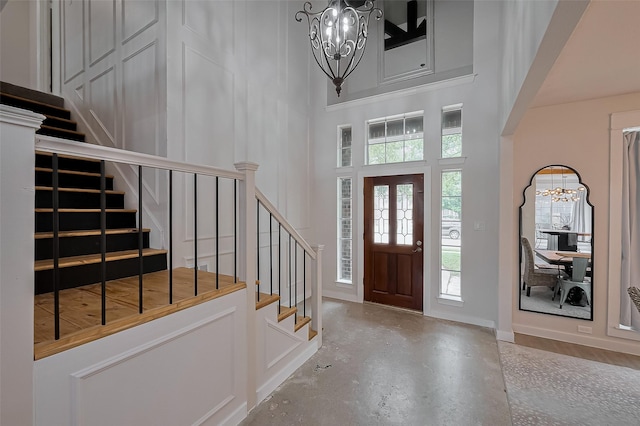 15610 Township Glen Ln, Cypress, TX 77433 - foyer entrance with a chandelier, concrete floors, stairs, and a towering ceiling