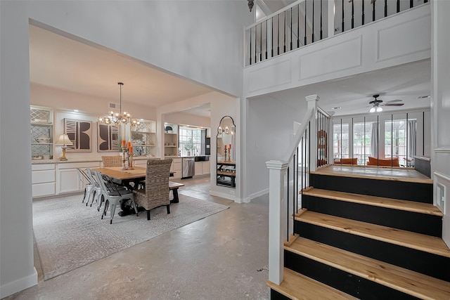15610 Township Glen Ln, Cypress, TX 77433 - dining space with stairs, a chandelier, a ceiling fan, and concrete flooring