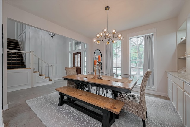 15610 Township Glen Ln, Cypress, TX 77433 - dining area with stairway, a chandelier, and finished concrete flooring