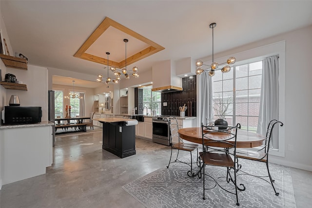 15610 Township Glen Ln, Cypress, TX 77433 - dining area with a chandelier, a tray ceiling, and finished concrete floors