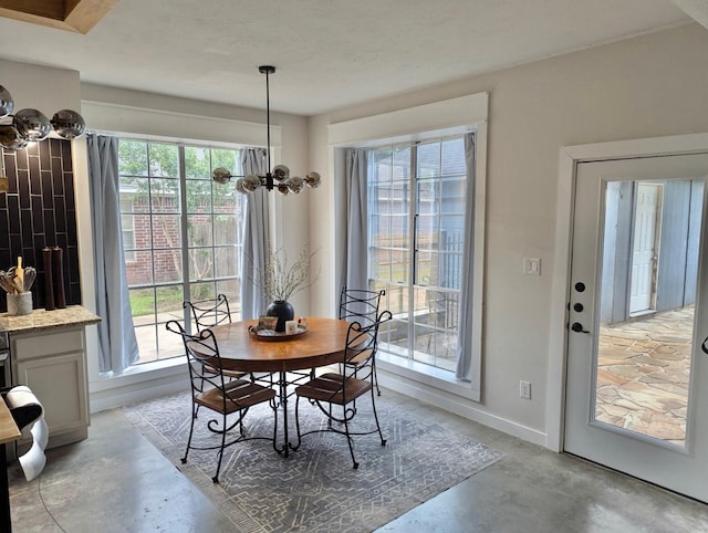 15610 Township Glen Ln, Cypress, TX 77433 - dining room with concrete flooring and a chandelier