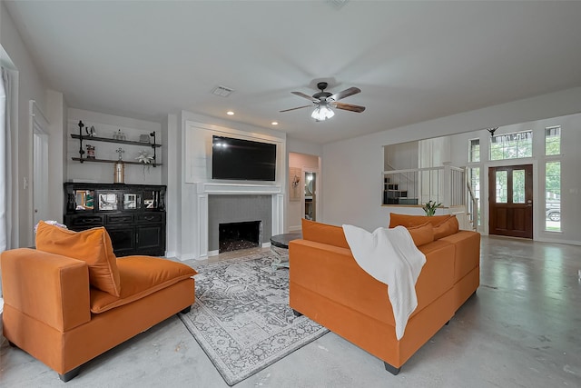 15610 Township Glen Ln, Cypress, TX 77433 - living area featuring a ceiling fan, a large fireplace, and finished concrete flooring