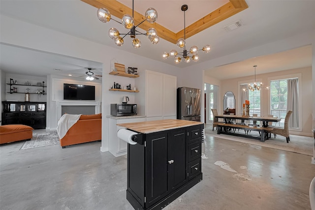 15610 Township Glen Ln, Cypress, TX 77433 - kitchen with dark cabinets, stainless steel fridge, a chandelier, and concrete floors