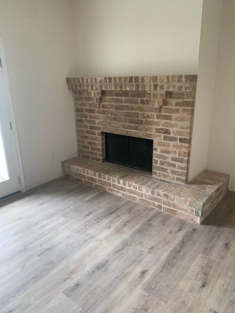 2425 Augusta Dr Unit 7, Houston, TX 77057 - detailed view of wood finished floors and a fireplace
