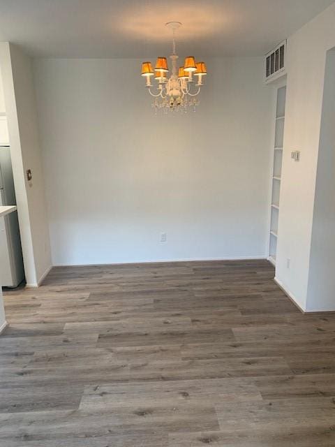 2425 Augusta Dr Unit 7, Houston, TX 77057 - unfurnished dining area with a chandelier and wood finished floors