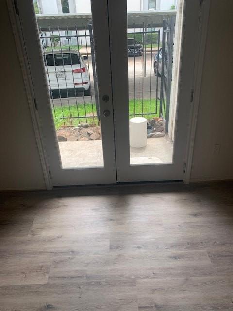 2425 Augusta Dr Unit 7, Houston, TX 77057 - doorway featuring french doors and wood finished floors