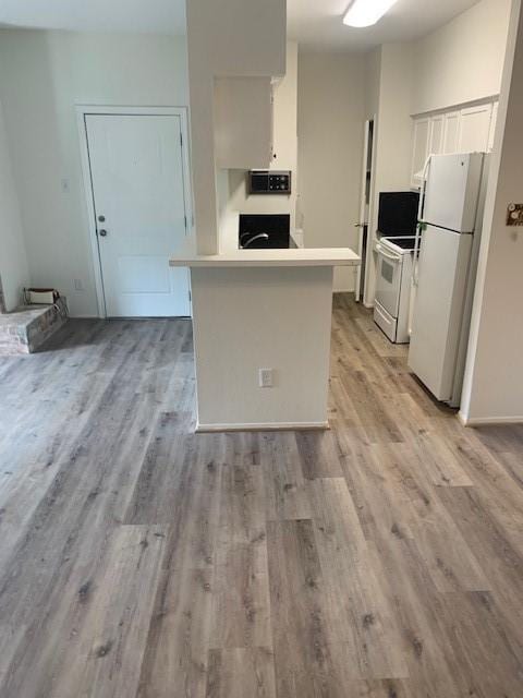 2425 Augusta Dr Unit 7, Houston, TX 77057 - kitchen with white appliances, white cabinetry, light wood-type flooring, and light countertops