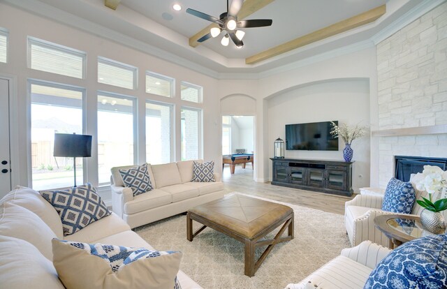 12607 Smokey Sunset Ct, Cypress, TX 77433 - living room featuring ceiling fan, a high ceiling, ornamental molding, a fireplace, and light wood-style floors