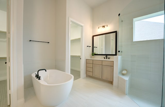 12607 Smokey Sunset Ct, Cypress, TX 77433 - full bathroom featuring a walk in closet, vanity, a freestanding tub, and tiled shower