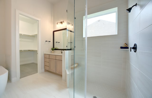12607 Smokey Sunset Ct, Cypress, TX 77433 - full bathroom with a stall shower, vanity, a spacious closet, and tile patterned floors