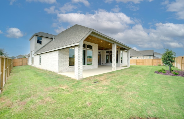 12607 Smokey Sunset Ct, Cypress, TX 77433 - rear view of house with a patio area, brick siding, a fenced backyard, and roof with shingles