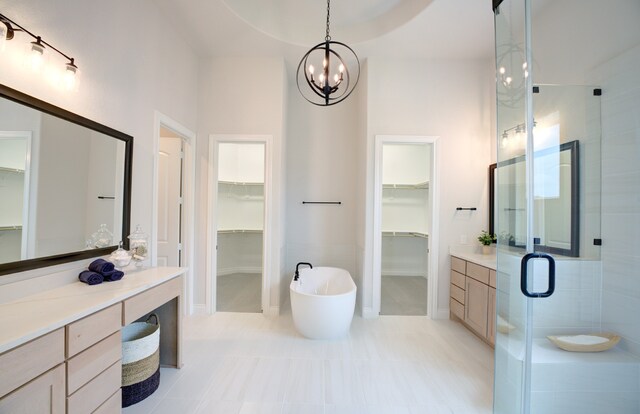 12607 Smokey Sunset Ct, Cypress, TX 77433 - bathroom with a walk in closet, vanity, and a shower stall