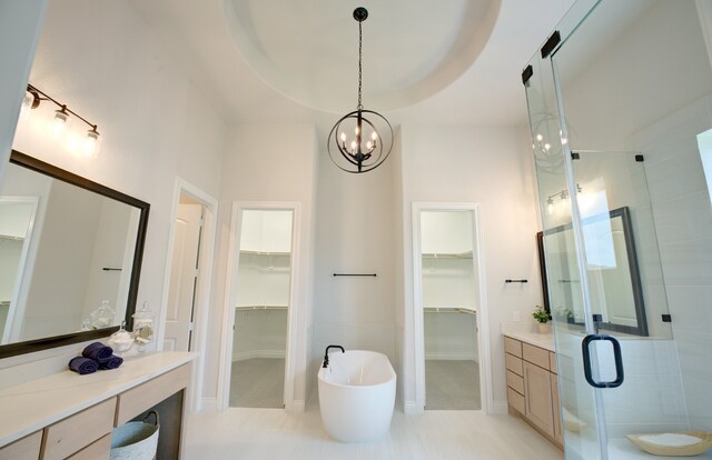 12607 Smokey Sunset Ct, Cypress, TX 77433 - full bath featuring a spacious closet, vanity, a shower stall, and a chandelier