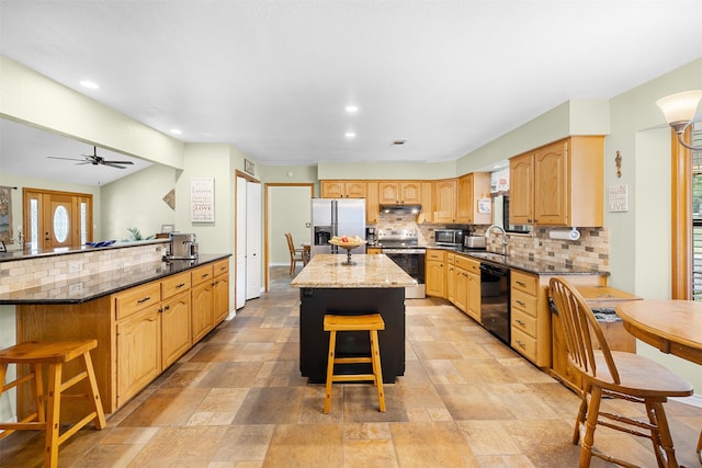 3135 Forest Hill E Rd, La Grange, TX 78945 - kitchen featuring stainless steel appliances, a kitchen breakfast bar, tasteful backsplash, recessed lighting, and dark stone countertops