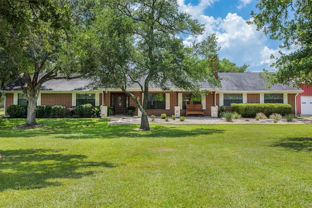 3135 Forest Hill E Rd, La Grange, TX 78945 - ranch-style house featuring a front lawn, brick siding, and an attached garage