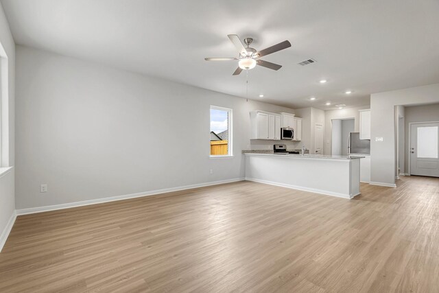 384 Tejas Trl, Waller, TX 77484 - unfurnished living room featuring a ceiling fan, light wood finished floors, and recessed lighting