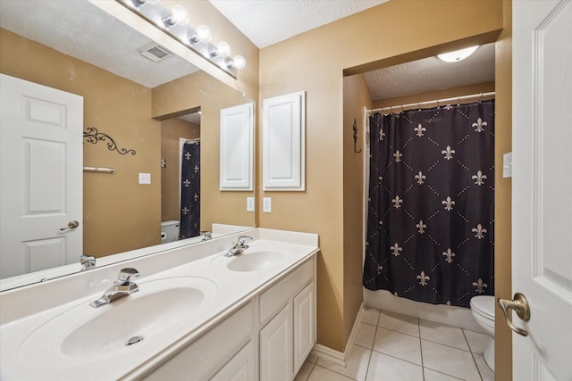 3732 Coral Reef Dr, Seabrook, TX 77586 - bathroom featuring tile patterned floors, double vanity, a shower with shower curtain, and a textured ceiling