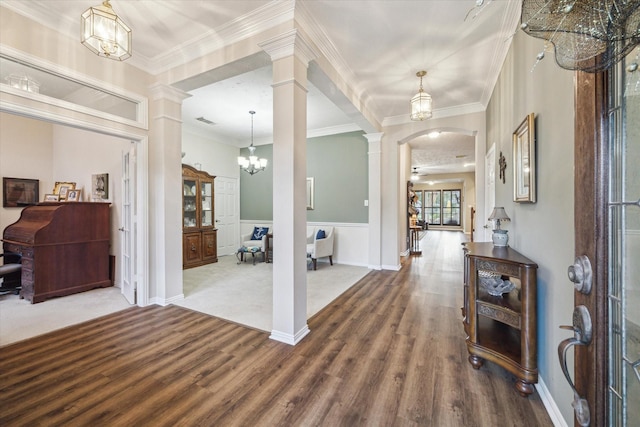 3732 Coral Reef Dr, Seabrook, TX 77586 - foyer entrance featuring ornate columns, a chandelier, wood finished floors, arched walkways, and ornamental molding