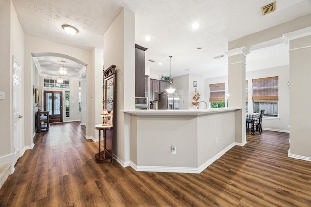 3732 Coral Reef Dr, Seabrook, TX 77586 - kitchen featuring dark wood-style flooring, arched walkways, light countertops, appliances with stainless steel finishes, and recessed lighting
