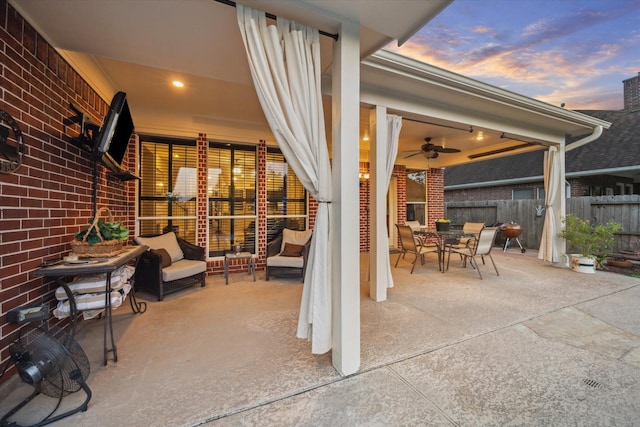 3732 Coral Reef Dr, Seabrook, TX 77586 - patio terrace at dusk with ceiling fan, outdoor dining space, a patio, and an outdoor living space