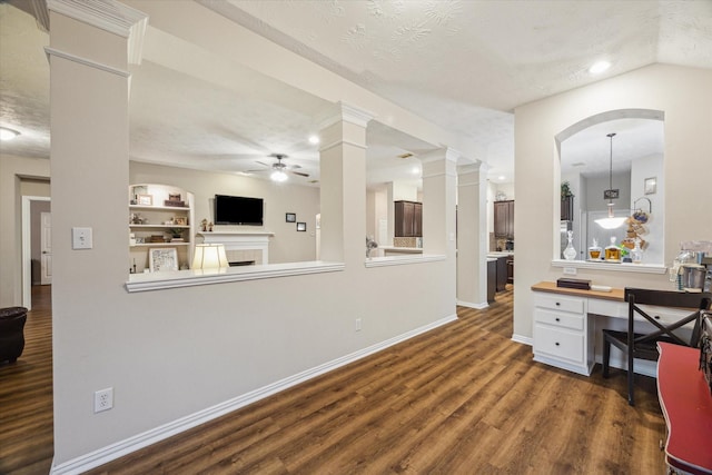 3732 Coral Reef Dr, Seabrook, TX 77586 - unfurnished office with ceiling fan, dark wood-style floors, a textured ceiling, a tile fireplace, and built in shelves