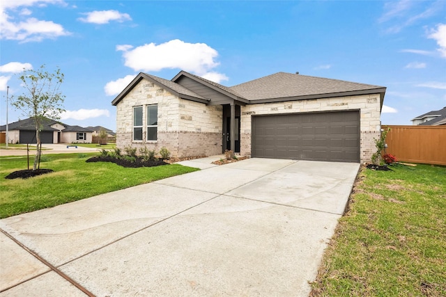 2435 Rooke Rd, Bryan, TX 77807 - view of front of property with an attached garage, concrete driveway, brick siding, and stone siding