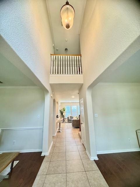 4126 Winesap Bend Dr, Stafford, TX 77477 - hall with a towering ceiling, arched walkways, wood finished floors, and crown molding