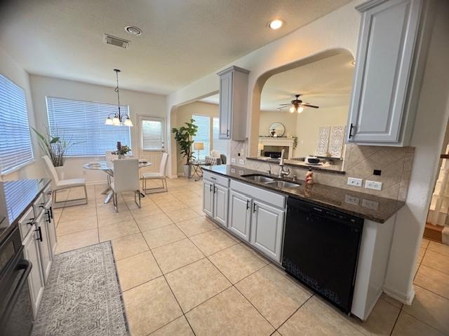 4126 Winesap Bend Dr, Stafford, TX 77477 - kitchen featuring black appliances, gray cabinets, arched walkways, tasteful backsplash, and ceiling fan