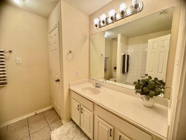 4126 Winesap Bend Dr, Stafford, TX 77477 - bathroom with vanity, tile patterned flooring, a textured ceiling, and a shower