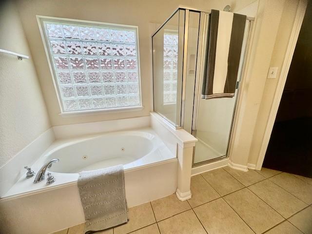 4126 Winesap Bend Dr, Stafford, TX 77477 - bathroom featuring a stall shower, a whirlpool tub, and tile patterned flooring