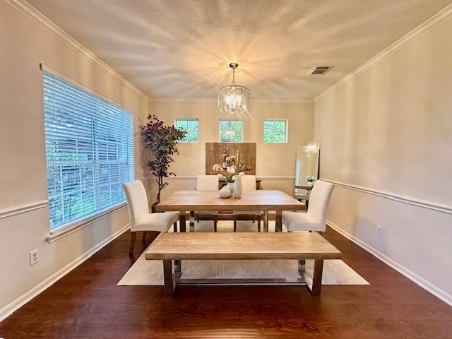4126 Winesap Bend Dr, Stafford, TX 77477 - dining room with a chandelier, wood finished floors, and crown molding