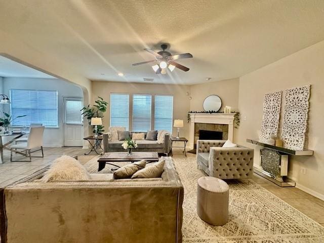 4126 Winesap Bend Dr, Stafford, TX 77477 - living area with ceiling fan, tile patterned flooring, and a fireplace