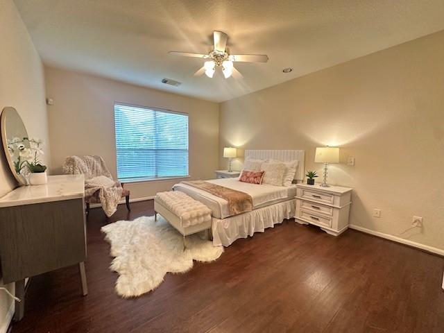4126 Winesap Bend Dr, Stafford, TX 77477 - bedroom featuring dark wood finished floors and a ceiling fan