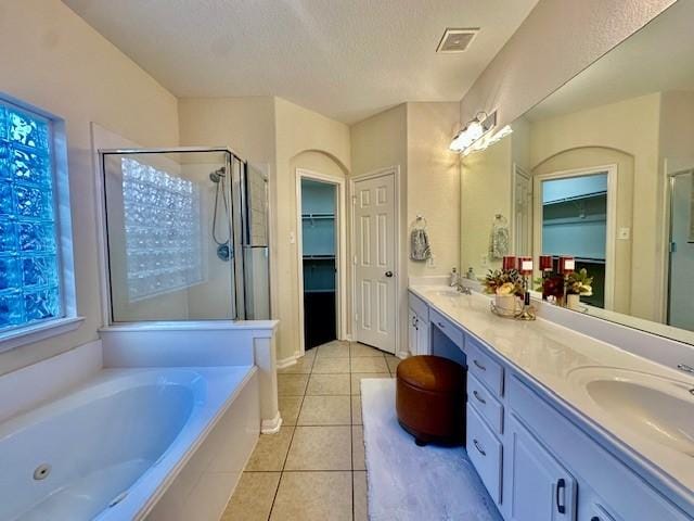 4126 Winesap Bend Dr, Stafford, TX 77477 - bathroom featuring a shower stall, double vanity, tile patterned flooring, a tub with jets, and a spacious closet