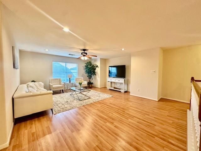 4126 Winesap Bend Dr, Stafford, TX 77477 - living area featuring a ceiling fan, light wood finished floors, and recessed lighting