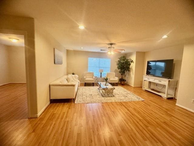 4126 Winesap Bend Dr, Stafford, TX 77477 - living area featuring wood finished floors, a ceiling fan, and recessed lighting