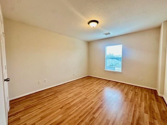 4126 Winesap Bend Dr, Stafford, TX 77477 - unfurnished room featuring wood finished floors and a textured ceiling