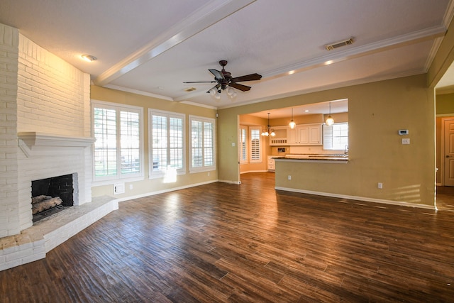 5838 Mountain View Dr, Houston, TX 77345 - unfurnished living room featuring a ceiling fan, a brick fireplace, dark wood-style flooring, crown molding, and beamed ceiling