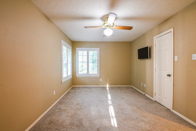 5838 Mountain View Dr, Houston, TX 77345 - unfurnished room featuring carpet floors, ceiling fan, and a textured ceiling