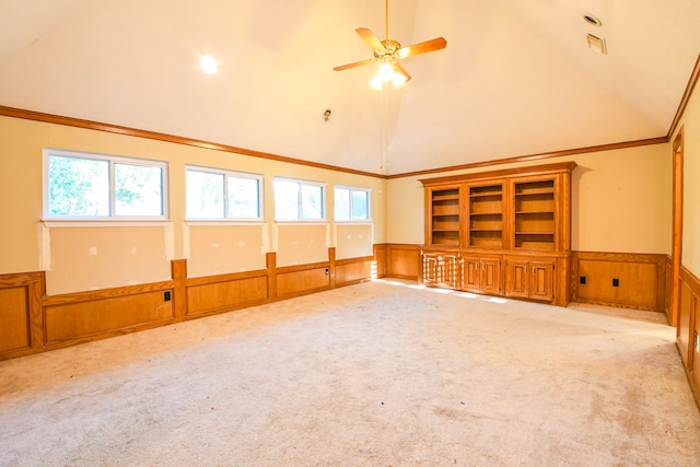 5838 Mountain View Dr, Houston, TX 77345 - unfurnished living room featuring a wainscoted wall, high vaulted ceiling, carpet, healthy amount of natural light, and ceiling fan