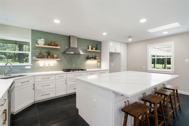 33933 Deer Creek Way, Stagecoach, TX 77355 - kitchen featuring wall chimney range hood, open shelves, tasteful backsplash, white cabinets, and recessed lighting