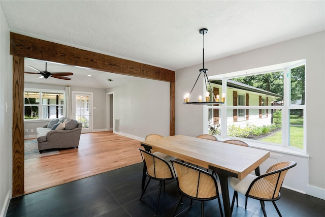 33933 Deer Creek Way, Stagecoach, TX 77355 - dining space with a chandelier, beamed ceiling, a ceiling fan, and dark wood finished floors