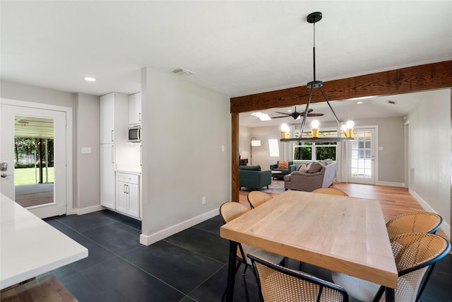 33933 Deer Creek Way, Stagecoach, TX 77355 - dining room featuring healthy amount of natural light, recessed lighting, dark tile patterned floors, and a chandelier