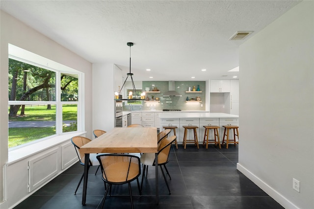 33933 Deer Creek Way, Stagecoach, TX 77355 - dining room with a textured ceiling and recessed lighting