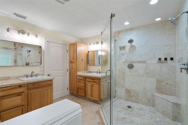 33933 Deer Creek Way, Stagecoach, TX 77355 - bathroom featuring a shower stall, vanity, tile patterned floors, and recessed lighting