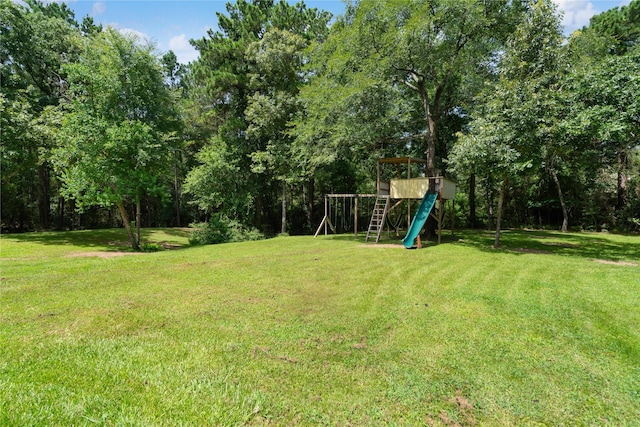 33933 Deer Creek Way, Stagecoach, TX 77355 - view of green lawn featuring a playground