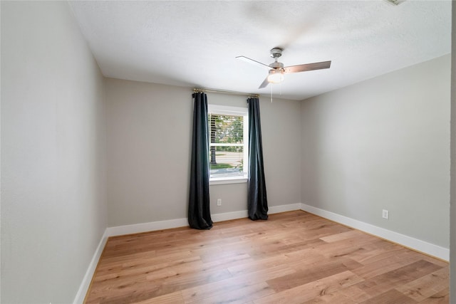 33933 Deer Creek Way, Stagecoach, TX 77355 - unfurnished room featuring light wood finished floors, ceiling fan, and a textured ceiling