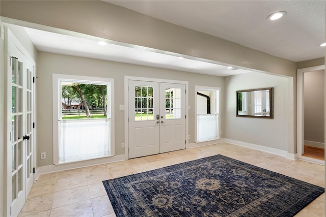33933 Deer Creek Way, Stagecoach, TX 77355 - foyer with french doors, plenty of natural light, light tile patterned floors, and recessed lighting